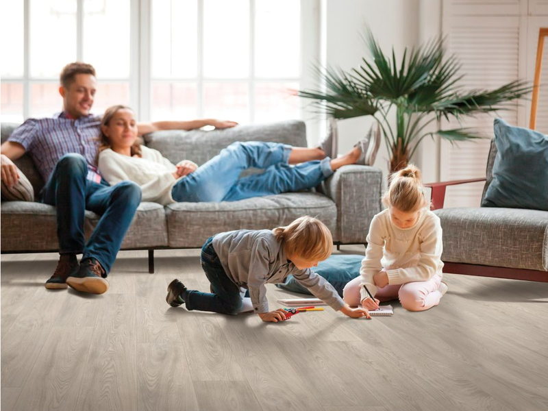 Children coloring and playing on durable Mohawk VersaTech floors.